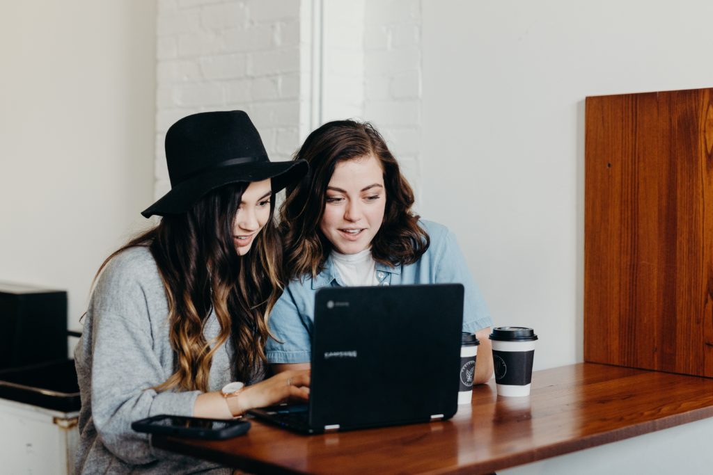 photo-of-two-girls-engaged-on-laptop
